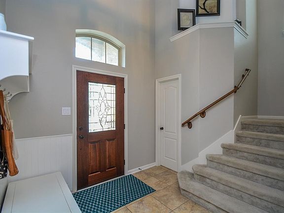 The sunlight floods into this beautiful entry! With a gorgeous glass dooryoull be proud to welcome your guests into this cheerful foyer.