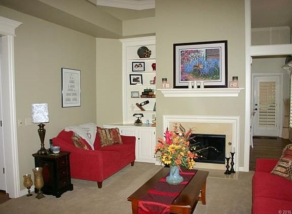 The formal living area in straight ahead and features high ceiling and built in bookcase.  The fireplace can be wood burning or gas log.