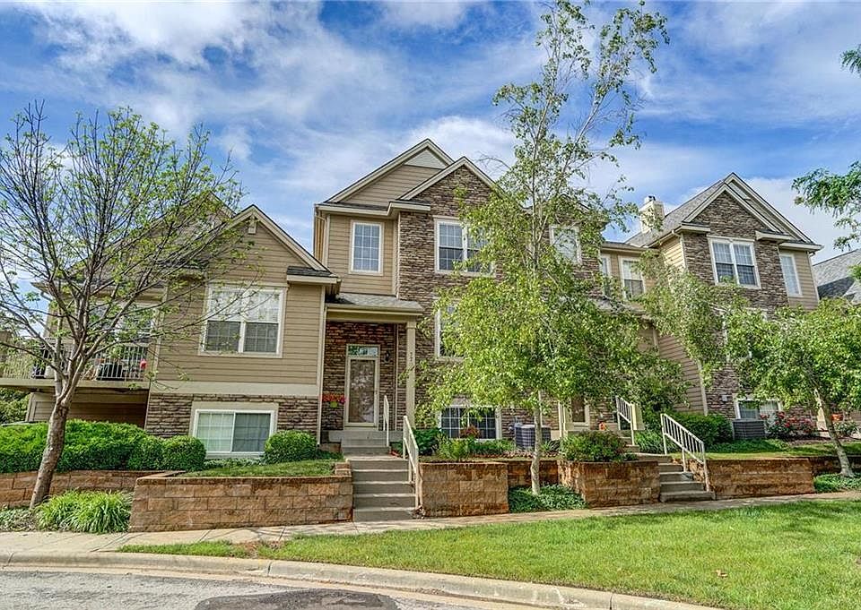 Landscaped front with trees, sidewalks and sprinkler system that keeps your entrance beautiful!