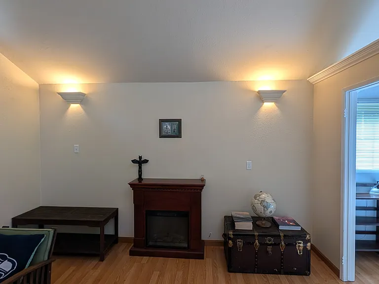 View of fireplace plus coffee table that can be moved when in use and there's also a blow up mattress in the trunk