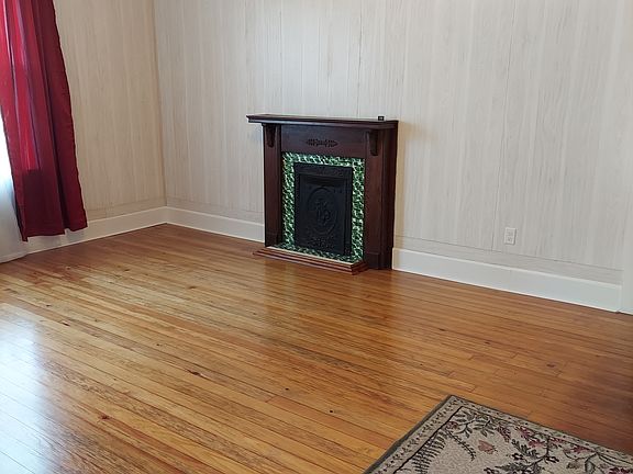 Large living area, new windows, fresh paint, and flooring. Window treatments remain.