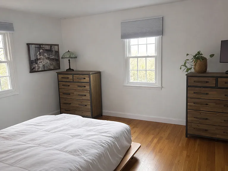 upstairs primary bedroom boasts king size bed and private primary bathroom.