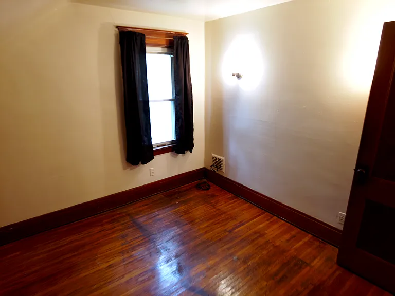 Bedroom with original hardwood floors.