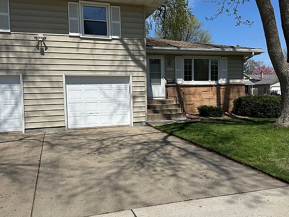 Indoor attached garage with large driveway for extra parking.