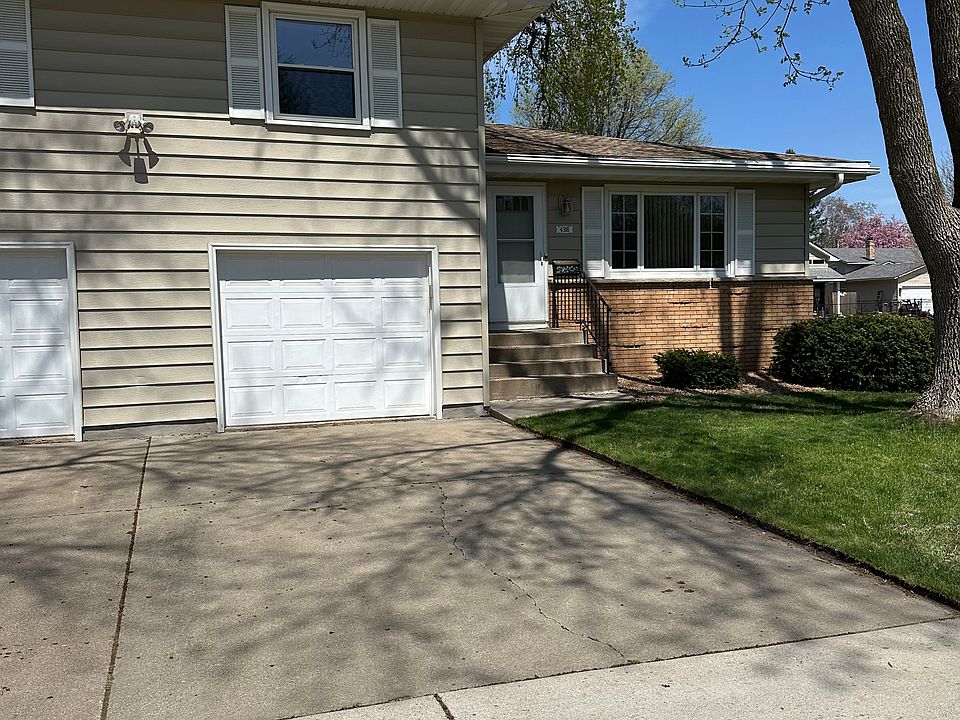 Indoor attached garage with large driveway for extra parking.