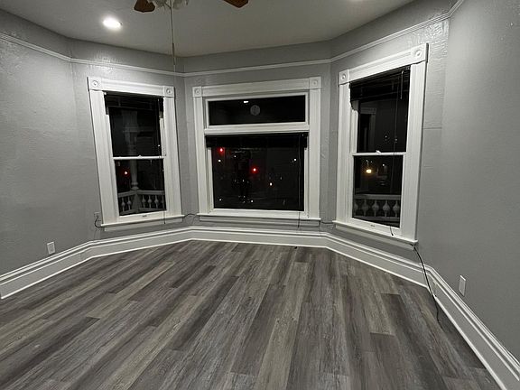 Living room with bay windows with plenty of natural light.
