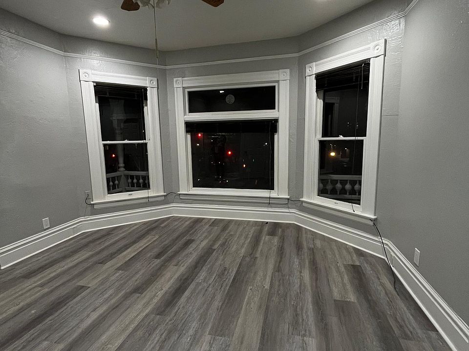 Living room with bay windows with plenty of natural light.