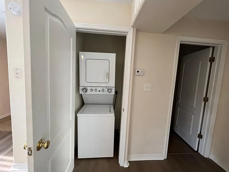 Stackable washer and dryer in the closet.