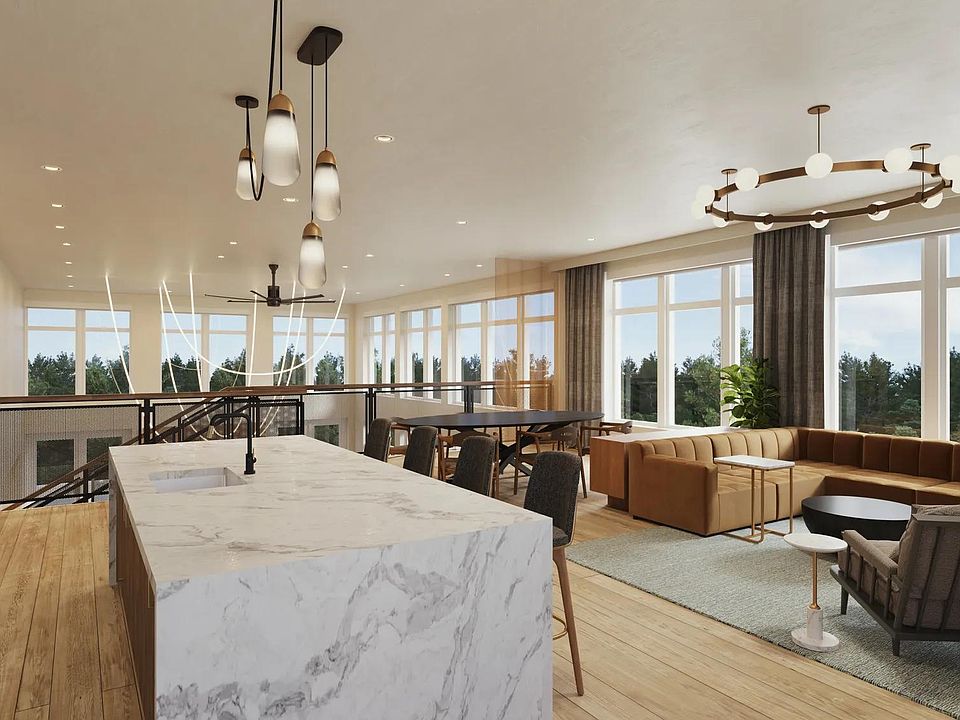 2nd-floor rooftop lounge at Modera Shoreline apartments features a demonstration kitchen, dining area, and comfortable seating.