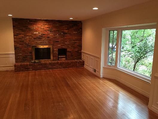Entrance to large living area with bay window, brick firepla