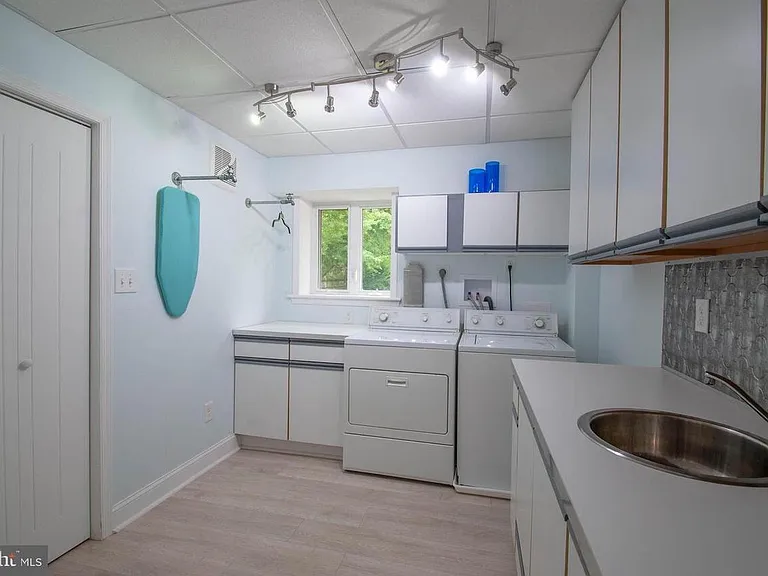 Laundry room with... you guessed it... even MORE storage!