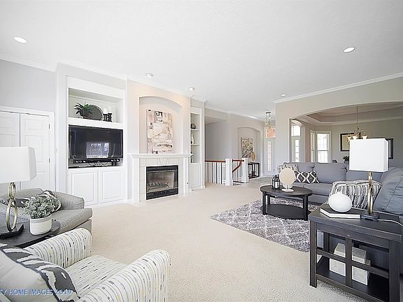 The custom built-ins house the mechanicals for the entertainment center and flank the gas-ignition, wood burning fireplace.