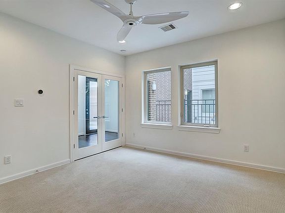 Downstairs study/bedroom with French doors to foyer.