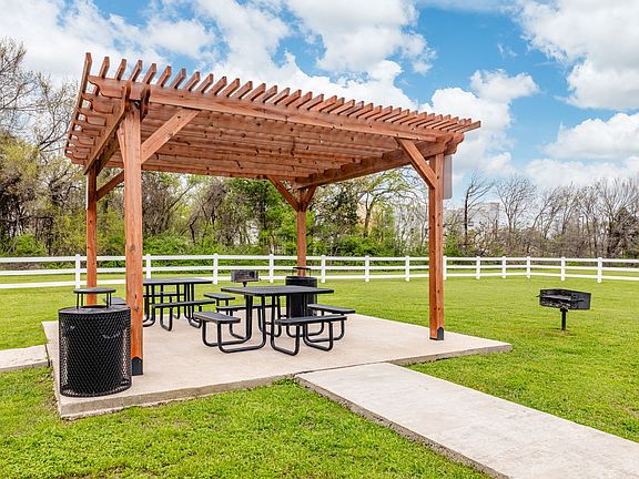Shaded outdoor picnic area with pergola seating, perfect for relaxing or entertaining