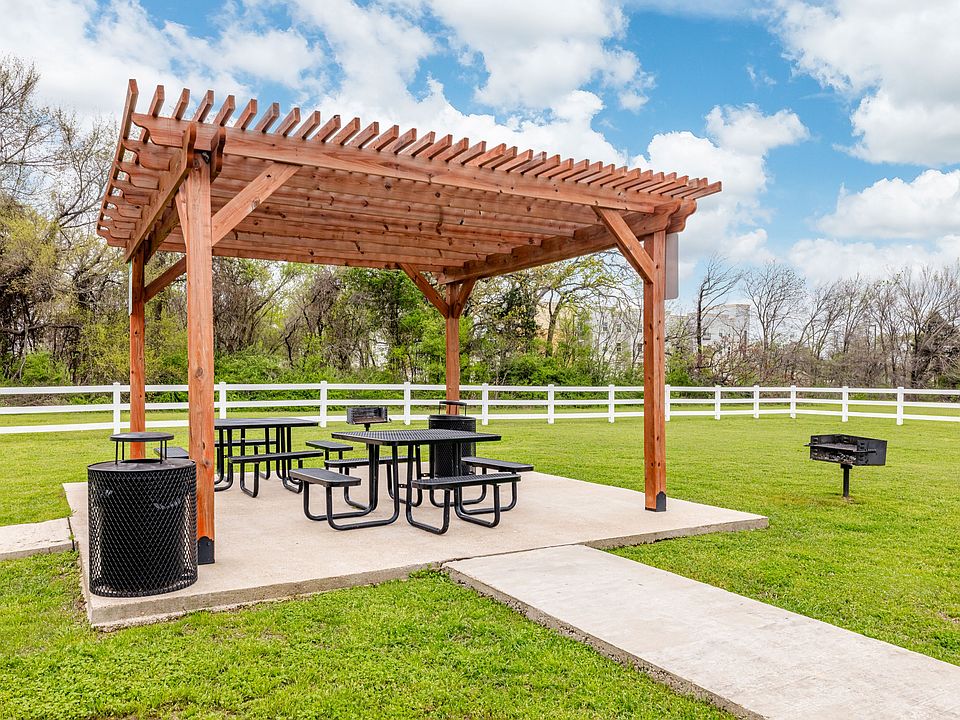 Shaded outdoor picnic area with pergola seating, perfect for relaxing or entertaining