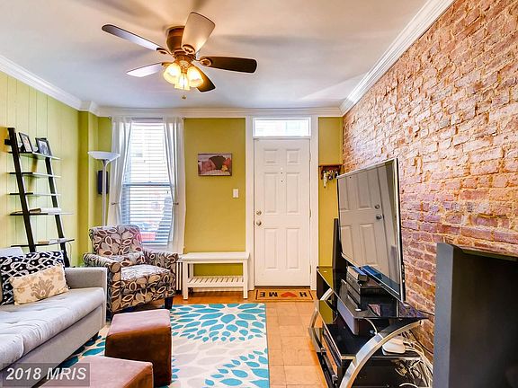 Living Room with Parquet Floors and Exposed Brick
