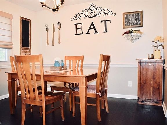 The dining area has laminate flooring and crown molding accents. Freshly painted.