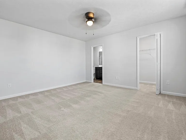Primary Bedroom Features Adjoining Bathroom, HUGE Walk In Closet and a NEW Ceiling Fan.