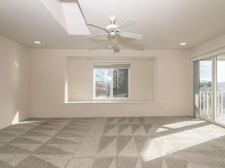 Master bedroom w/window bench & slider out to deck