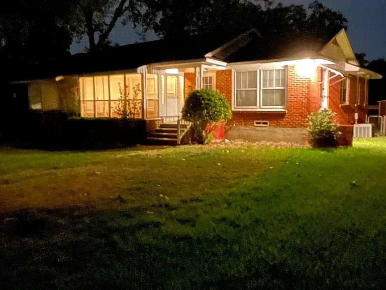 The house lit at night.