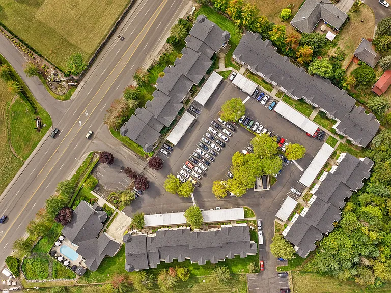 Aerial view showcasing the community layout with residential buildings and parking areas.