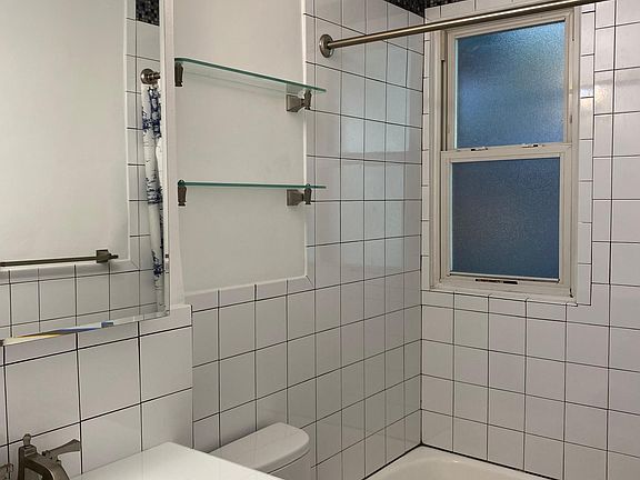 Renovated bathroom with large vanity and good storage space.