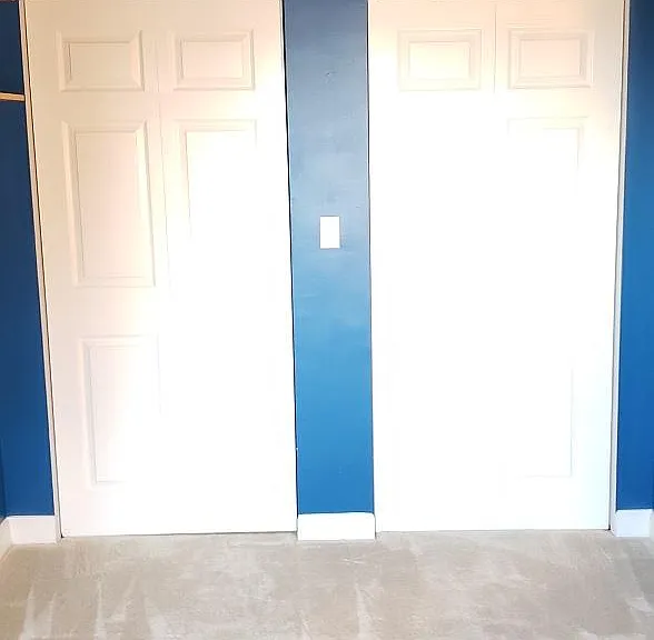 Bedroom looking south at folding closet doors.