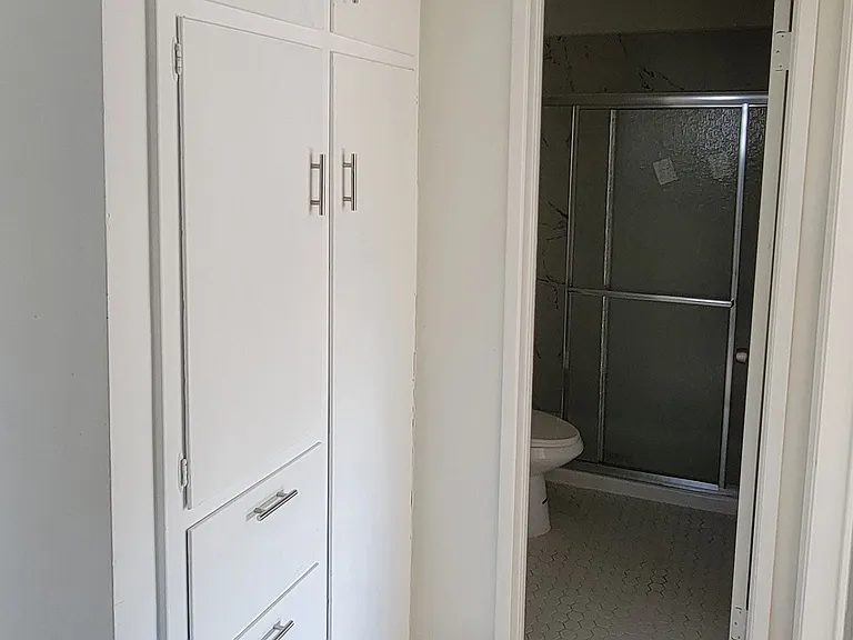 Bedroom hallway with lots of closet space in 2-bedroom apartment at the Hardison Apartments in Pasadena, California.