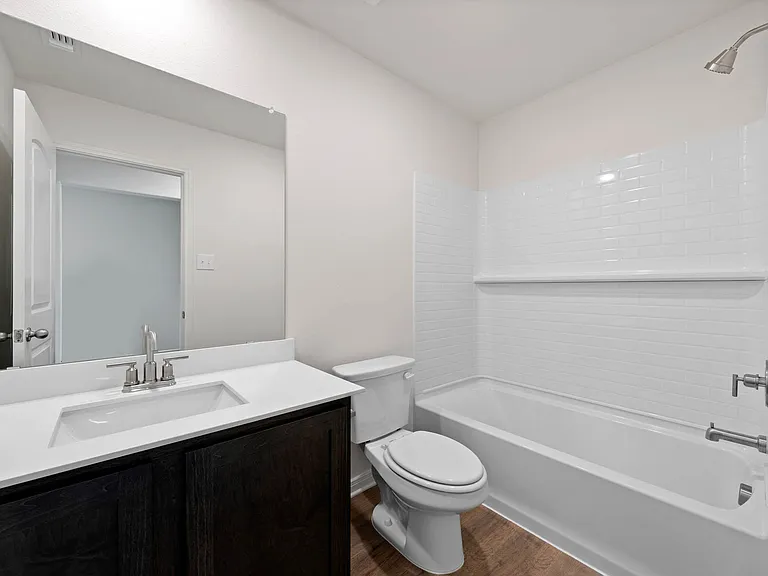 The secondary bathroom has a large vanity space.