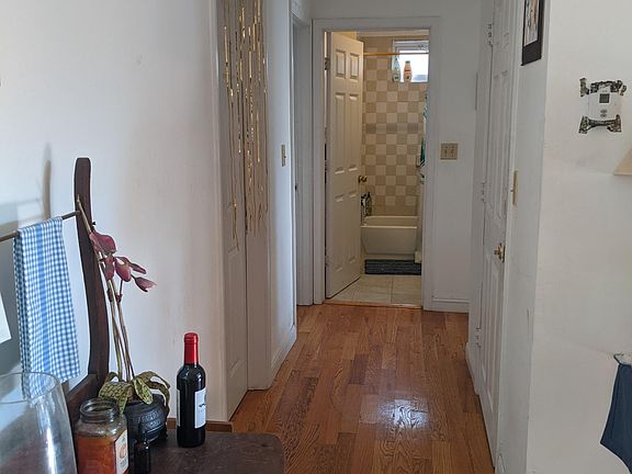 Hallway with 3 bedrooms to the left and the large 'extension' closet to the right