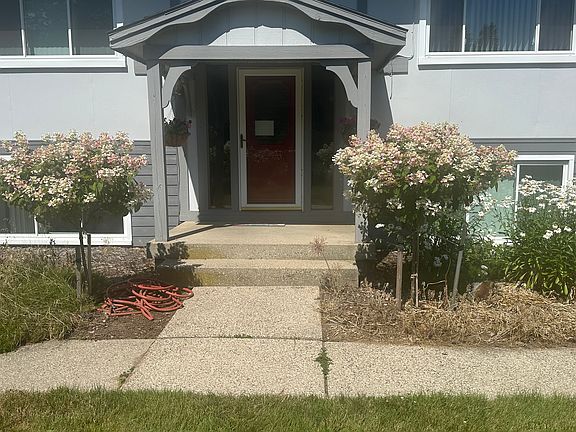 Front of entrance. Home is sounded with flowers and Birds. We maintain yard professionally. We have deeded access from backyard.