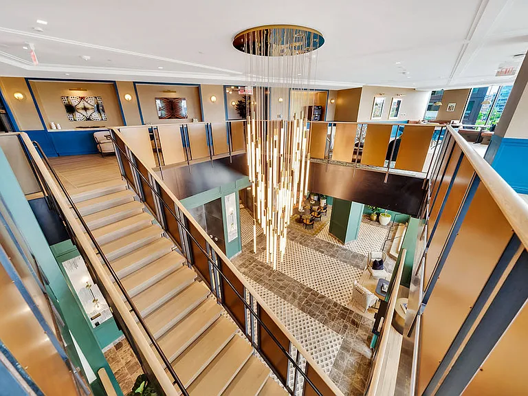 Lobby grand staircase leading to the coworking lounge.