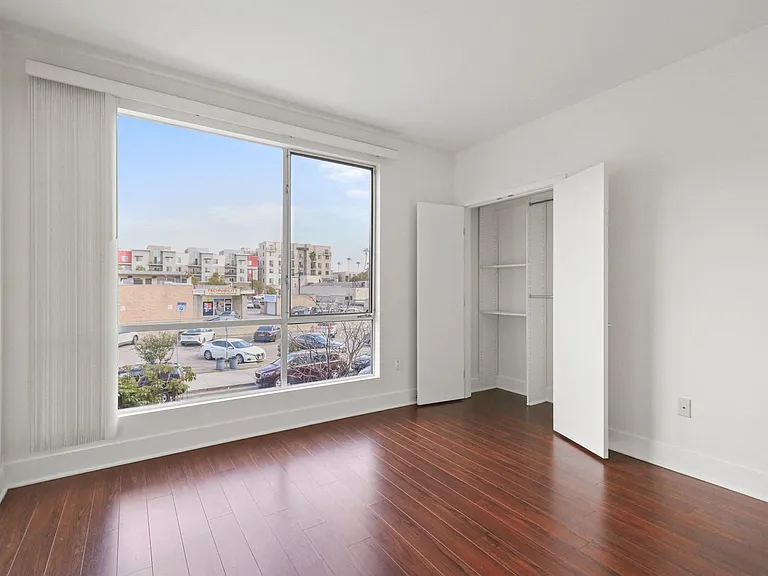 Bedroom with Closet, Vinyl Flooring, and Large-Size Windows
