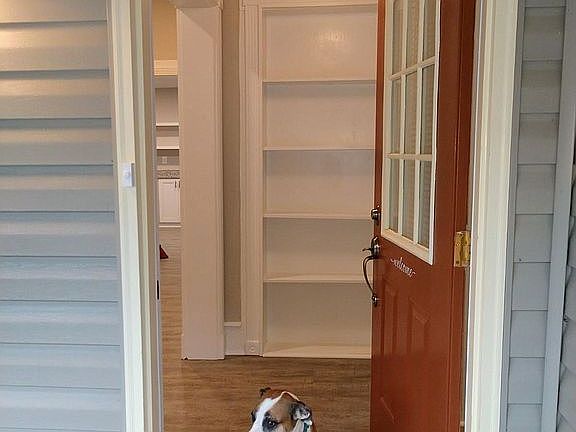 Front entry with built-in for photos and books. Renovated 1910 home with three large bedrooms, family room with space for dining table; renovated kitchen with stainless steel appliances, gas stove. Laundry room includes washer and dryer for your convenien