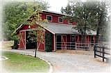 2 barns on property offer total of 9 stalls, large paddocks, hay storage, tack