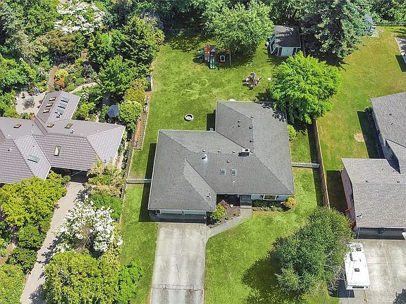 Aerial view of home shows large back yard.>