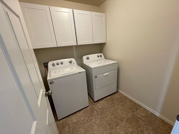 laundry room with storage; new washer and dryer included