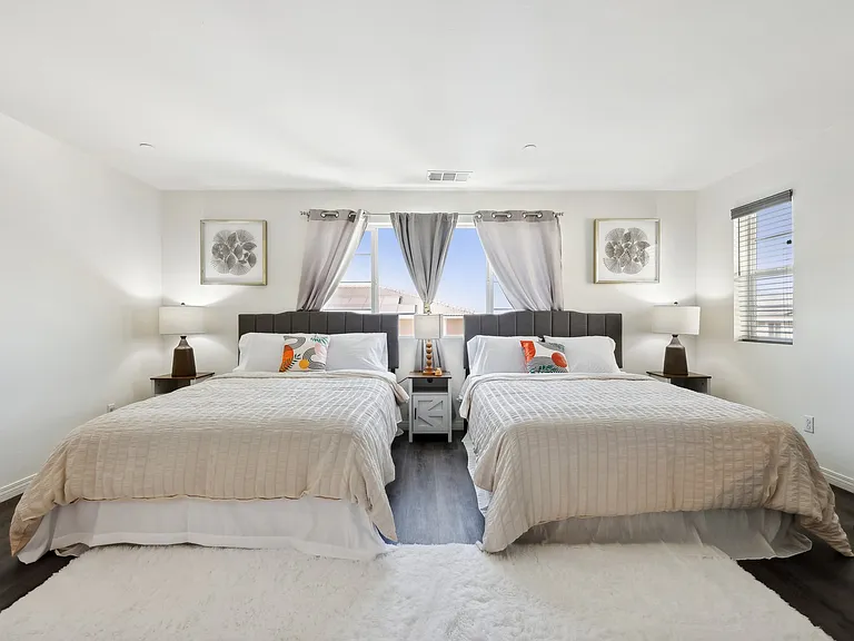Double the comfort! This spacious bedroom with two queen-size beds is perfect for a restful getaway.
