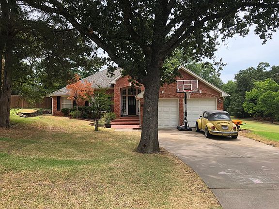 Extra long driveway and secluded lot with multiple trees on
