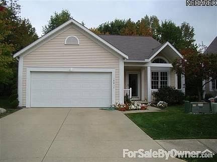 Street view - Wide drive to 2 car garage
						:
						Gabled entry over front porch. Best tree on the block for bird watching.