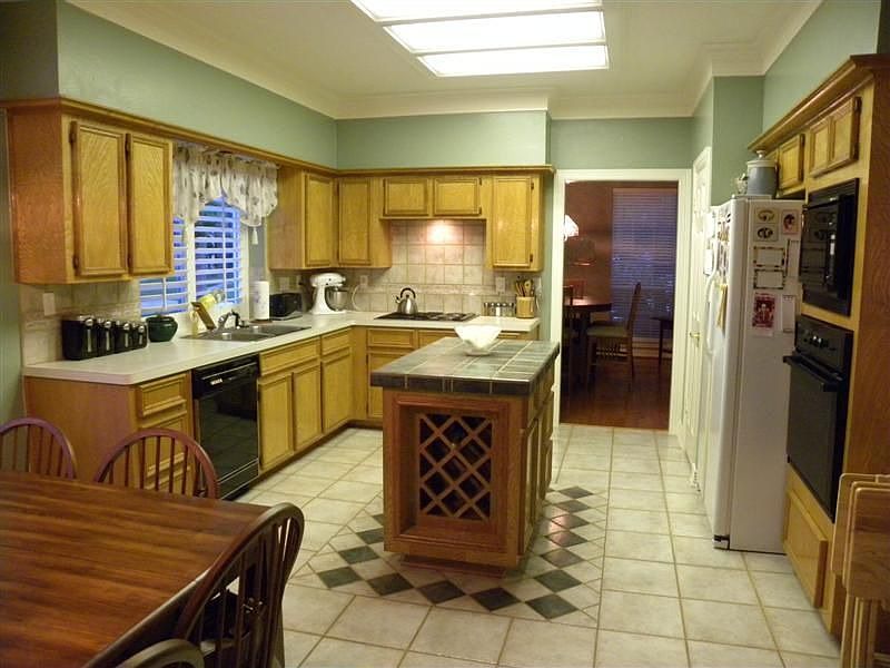 Huge kitchen with loads of cabinet space, built in wine rack in island, built 