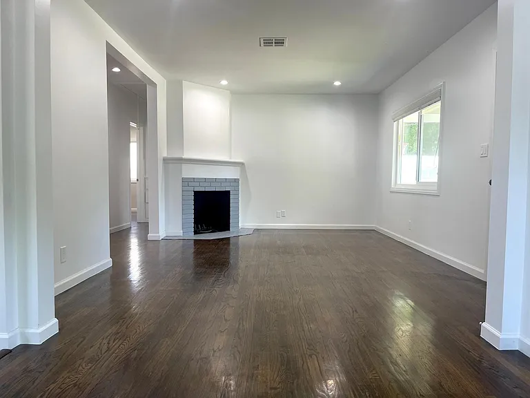 Living room - front door is to the right. Kitchen is immediately to the left and the hallway to the den and bedrooms is to the left of the fireplace.