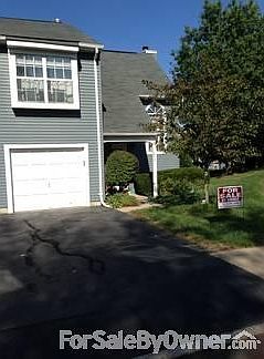 Front View of Home
						:
						Front of the Town House featuring a one-car garage with storage, and driveway!