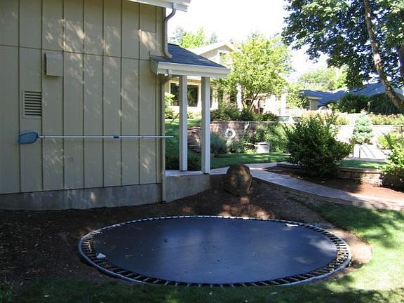 inground trampoline and poolhouse