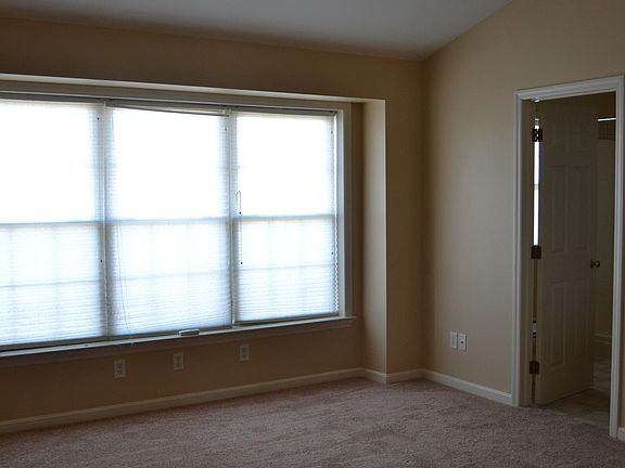 MBR with fan and vaulted ceiling looking toward master bath