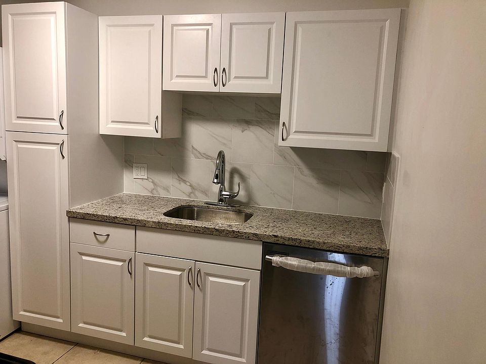 Gorgeously remodeled kitchen with quartz counters and stainless steel appliances.