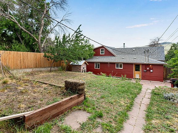 Fenced in back yard looking from the garage.
