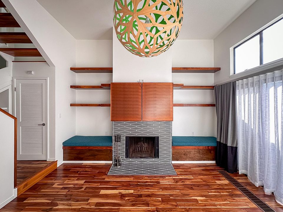 Living room with wood burning fireplace and TV cabinet