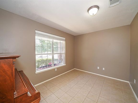The front study has a large window, French doors  and tiled floors !