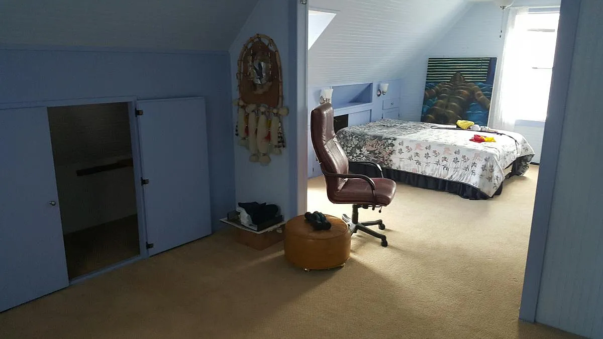 view from the 3 large window showing the lounge area and bed